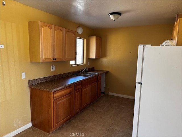 kitchen with sink and white fridge