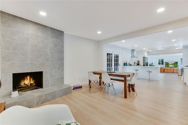 dining area with a fireplace and light wood-type flooring