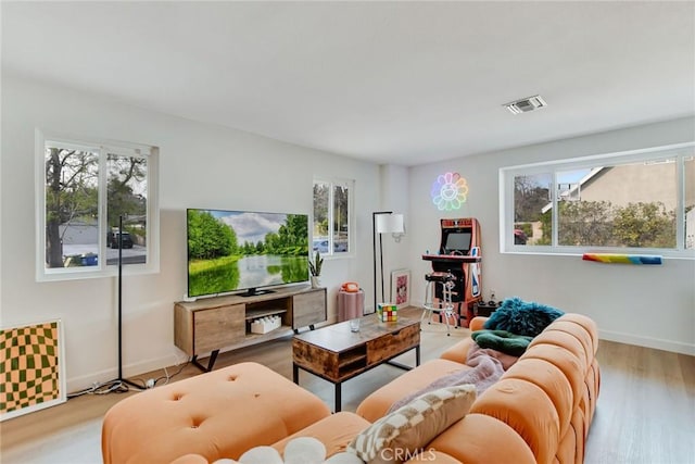 living room featuring plenty of natural light and light hardwood / wood-style floors