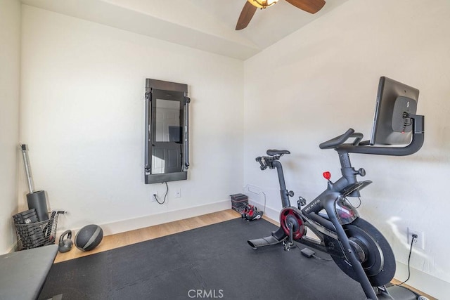 workout room with ceiling fan, hardwood / wood-style flooring, and lofted ceiling