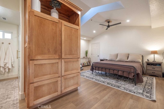 bedroom featuring vaulted ceiling, ceiling fan, and light hardwood / wood-style floors