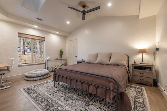 bedroom featuring wood-type flooring, high vaulted ceiling, and ceiling fan