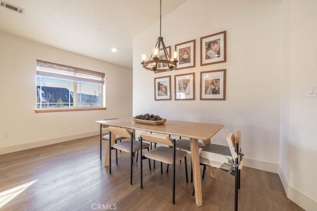 dining room featuring a chandelier and wood-type flooring