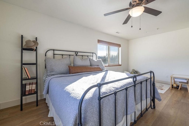 bedroom with hardwood / wood-style floors and ceiling fan