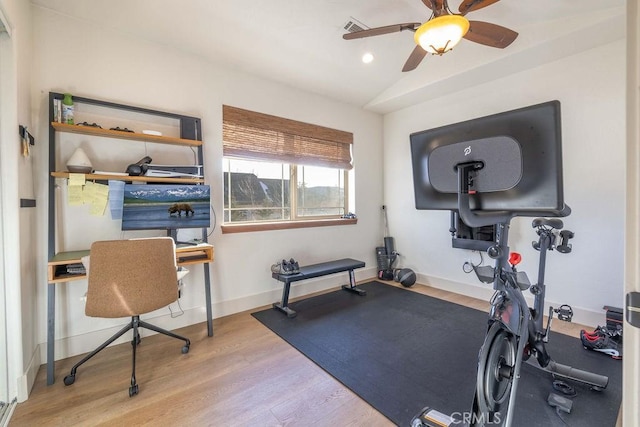 workout room with ceiling fan, light hardwood / wood-style flooring, and lofted ceiling