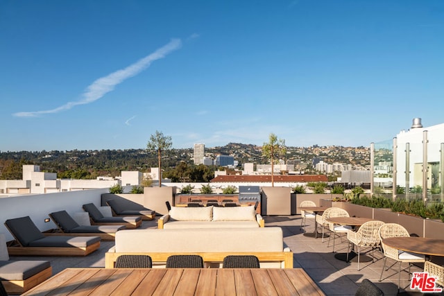 wooden deck with an outdoor living space and a patio area