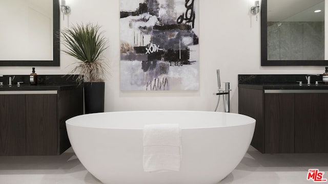 bathroom with vanity and a bathtub