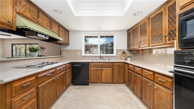 kitchen featuring black appliances, light tile patterned floors, decorative backsplash, and sink