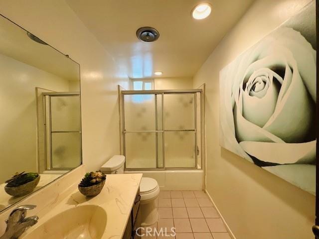 full bathroom with shower / bath combination with glass door, vanity, toilet, and tile patterned flooring