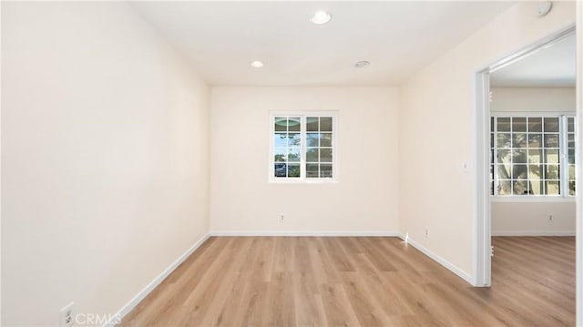 spare room with light hardwood / wood-style flooring