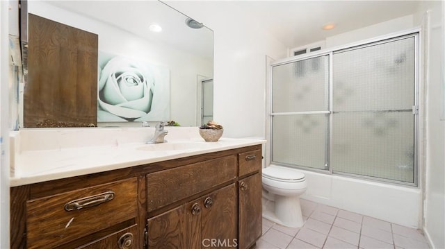 full bathroom featuring vanity, toilet, enclosed tub / shower combo, and tile patterned floors