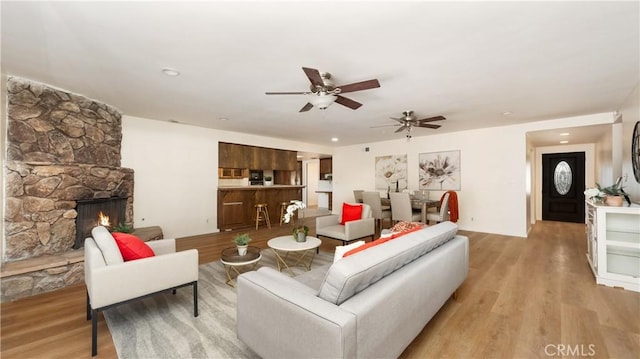 living room with light wood-type flooring and a fireplace