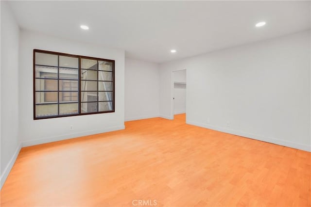 spare room with light wood-type flooring