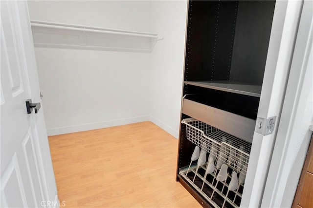 spacious closet featuring hardwood / wood-style floors