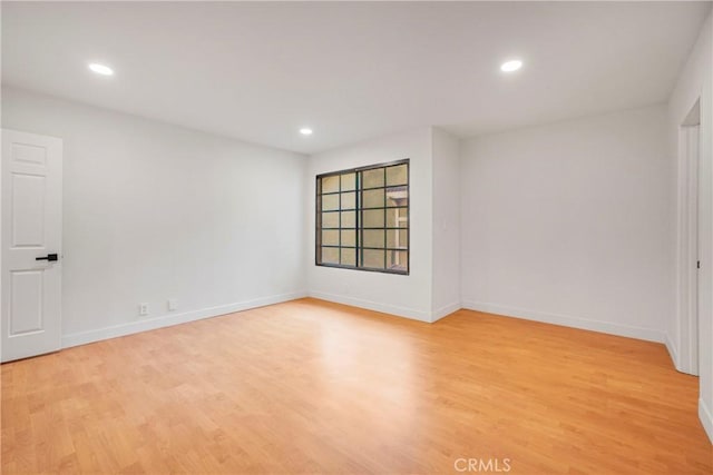 spare room with light wood-type flooring