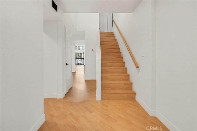 stairway featuring hardwood / wood-style floors