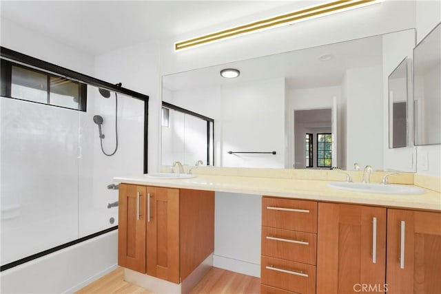 bathroom featuring vanity, shower / bath combination with glass door, and hardwood / wood-style floors