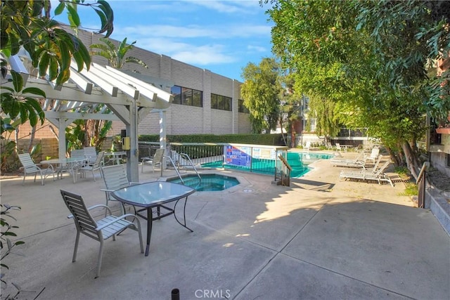 view of pool with a patio area, a community hot tub, and a pergola