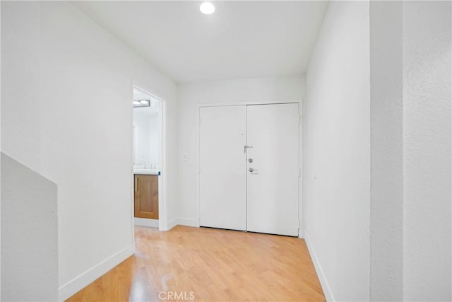 hall with light hardwood / wood-style flooring