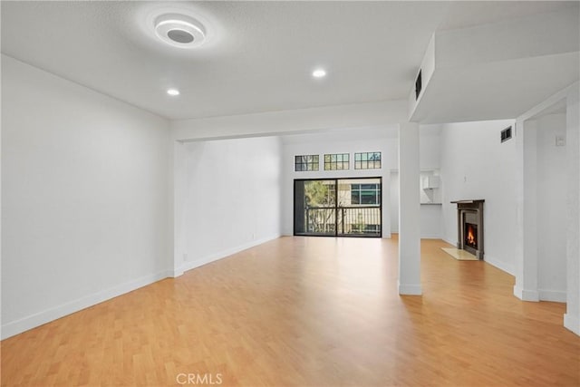 unfurnished living room featuring light hardwood / wood-style floors