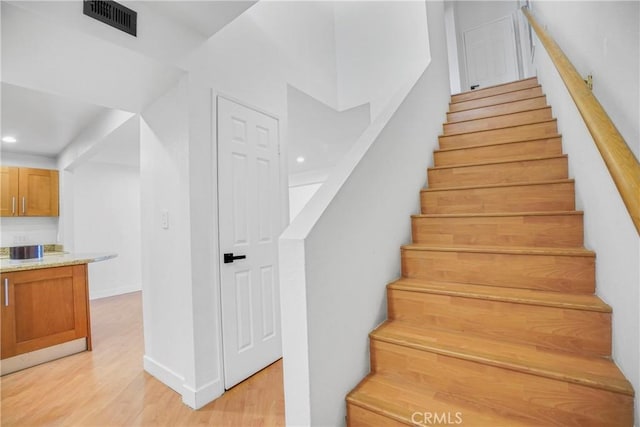 stairway featuring wood-type flooring