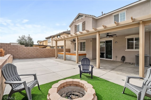 view of patio / terrace featuring ceiling fan, an outdoor fire pit, and cooling unit