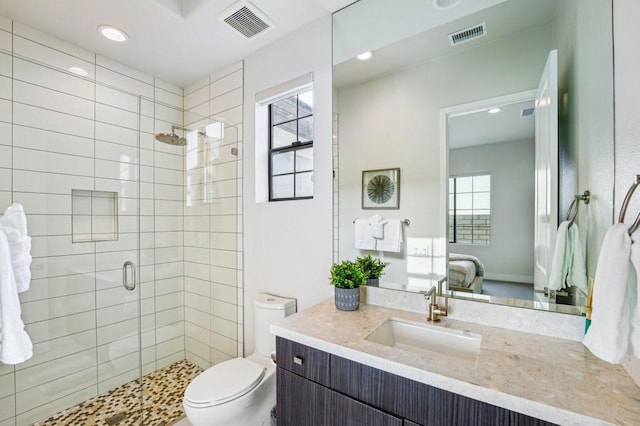 bathroom with vanity, toilet, and walk in shower