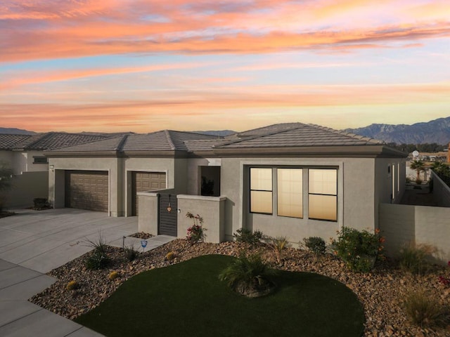 prairie-style house with a garage and a mountain view