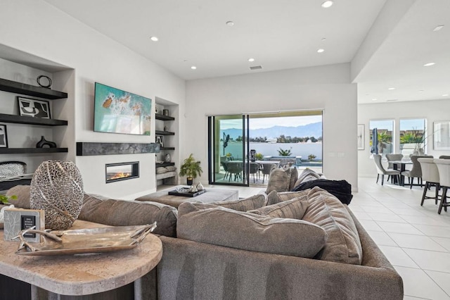 living room featuring light tile patterned floors and built in features