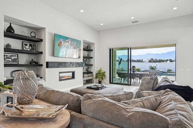 living room featuring tile patterned flooring and built in shelves