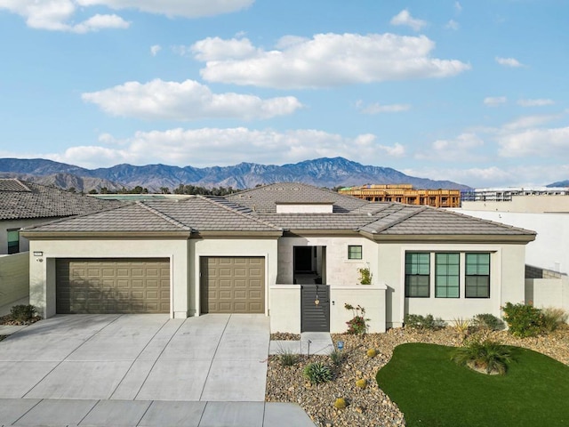 view of front of house with a garage and a mountain view