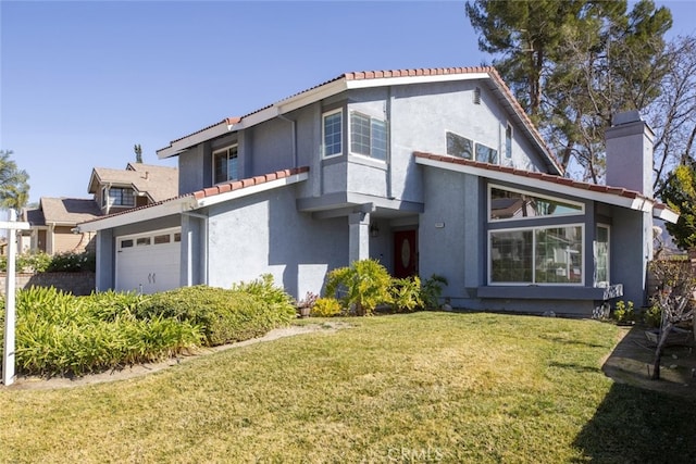 view of front of property with a garage and a front yard