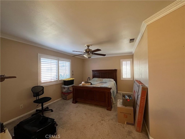 carpeted bedroom with ceiling fan and ornamental molding