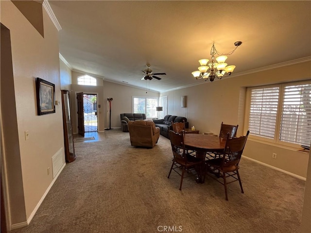 carpeted dining area featuring vaulted ceiling, ceiling fan with notable chandelier, and ornamental molding