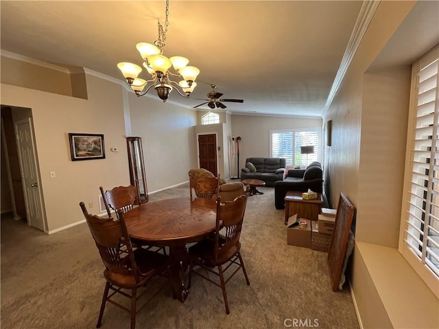 dining area featuring ceiling fan with notable chandelier, carpet flooring, and ornamental molding