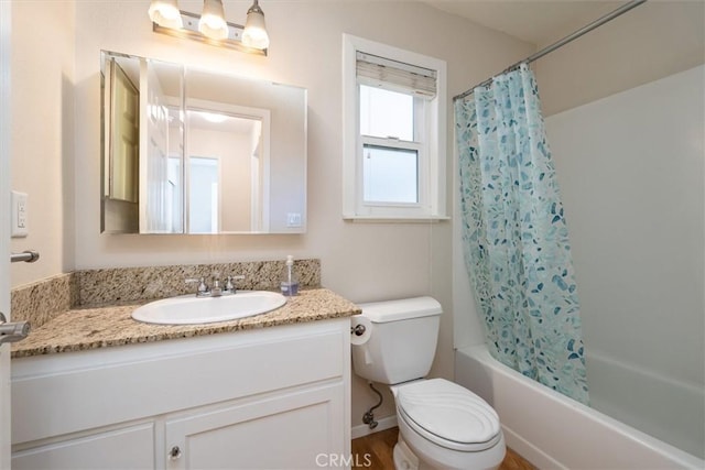 full bathroom featuring toilet, vanity, and shower / bath combo with shower curtain