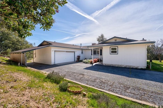 ranch-style home featuring a garage