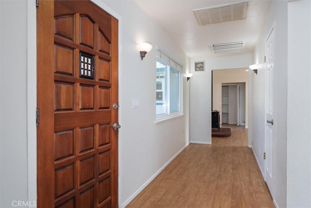 corridor with light wood-type flooring