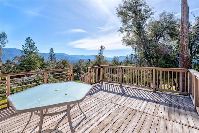 wooden deck with a mountain view