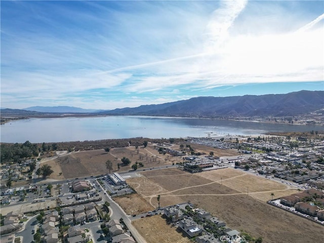 birds eye view of property with a water and mountain view