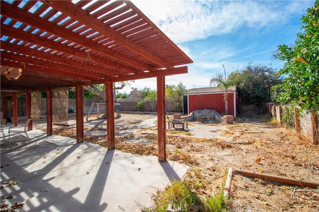 view of patio with a fenced backyard, an outdoor structure, a storage shed, and a pergola