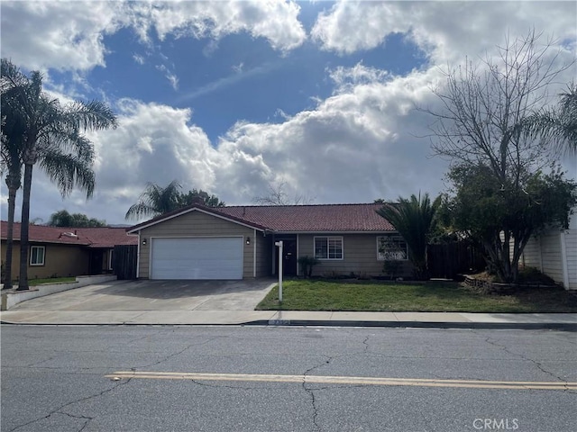 ranch-style home featuring a front yard, driveway, and an attached garage