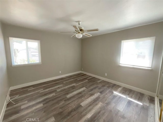 unfurnished room featuring ceiling fan and dark wood-type flooring