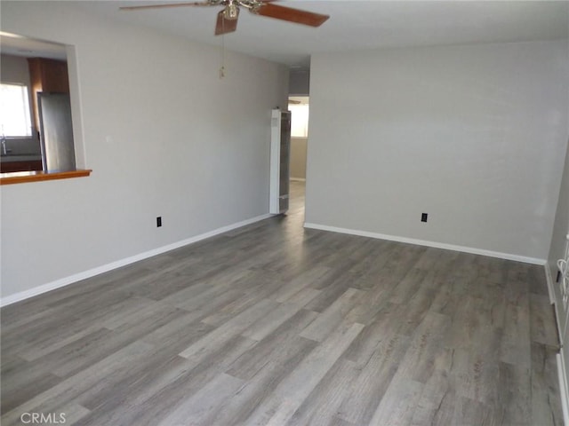 empty room with hardwood / wood-style floors and ceiling fan