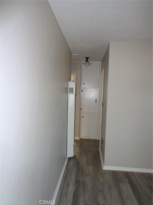 hallway with dark hardwood / wood-style flooring