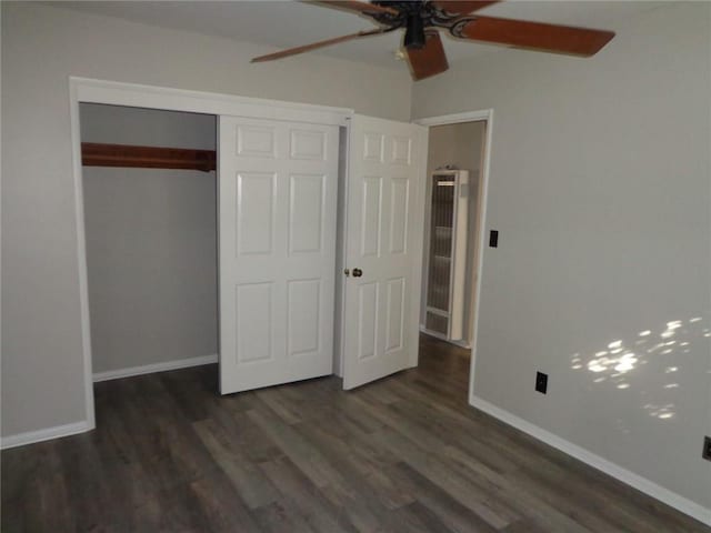 unfurnished bedroom featuring dark hardwood / wood-style floors, a closet, vaulted ceiling, and ceiling fan