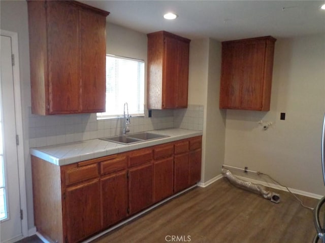 kitchen featuring sink, backsplash, tile countertops, and dark hardwood / wood-style flooring