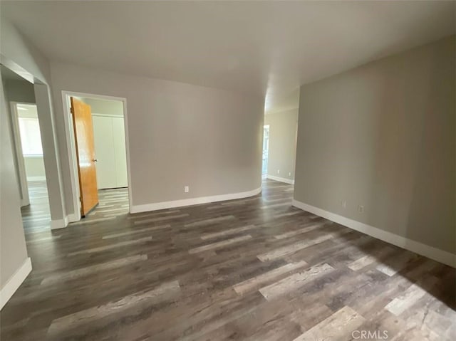 unfurnished room with dark hardwood / wood-style floors