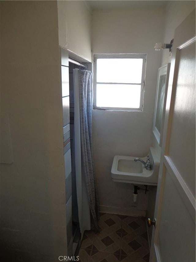 bathroom with sink and a shower with curtain