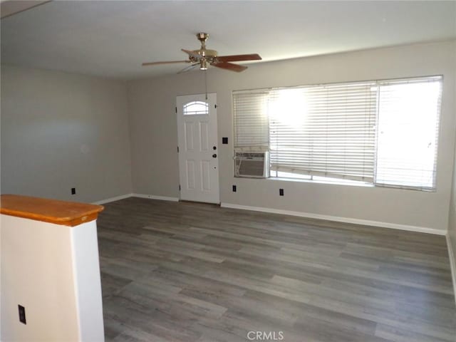 foyer entrance with cooling unit, ceiling fan, and dark hardwood / wood-style flooring